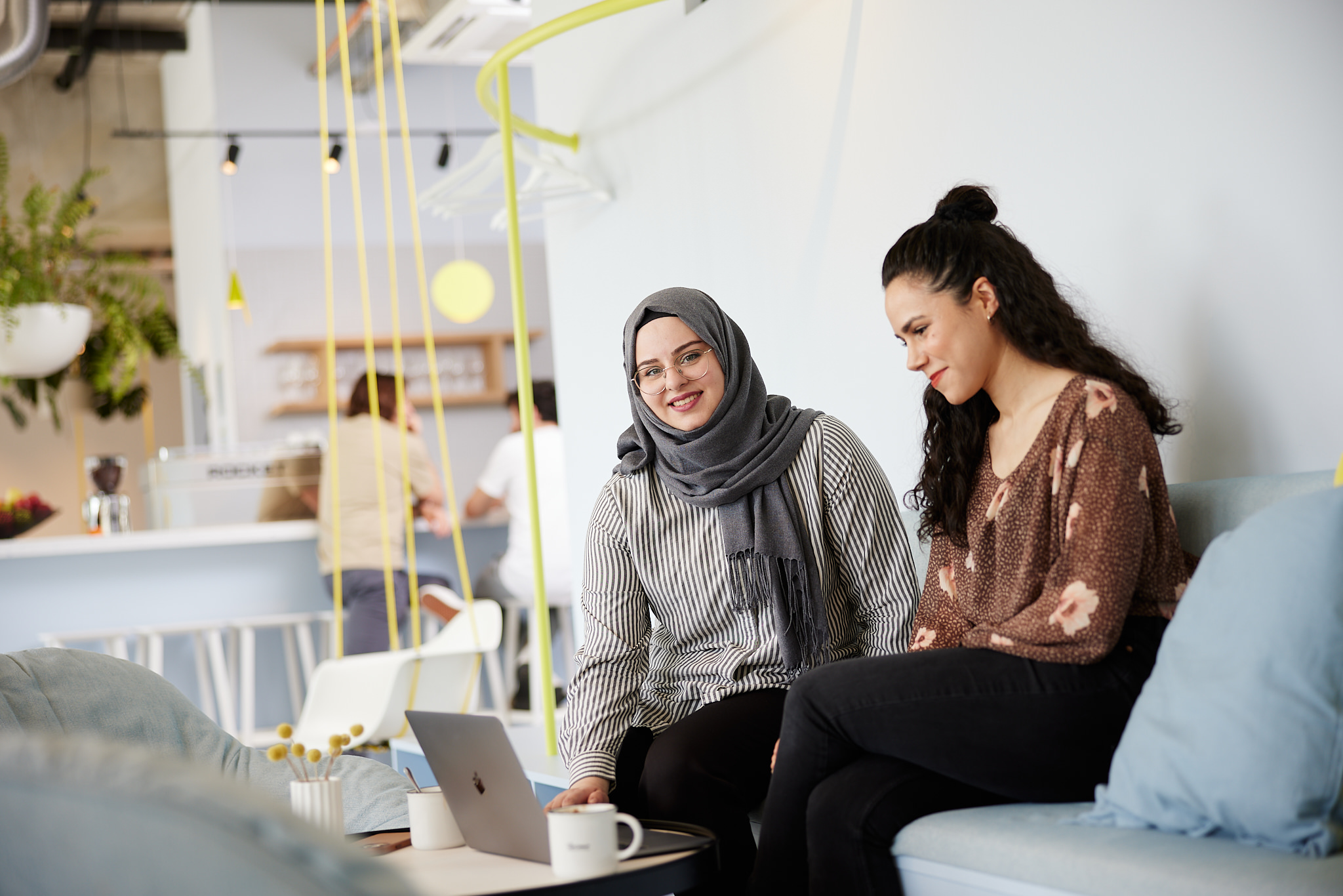 Two Co-Workers sitting on Couch