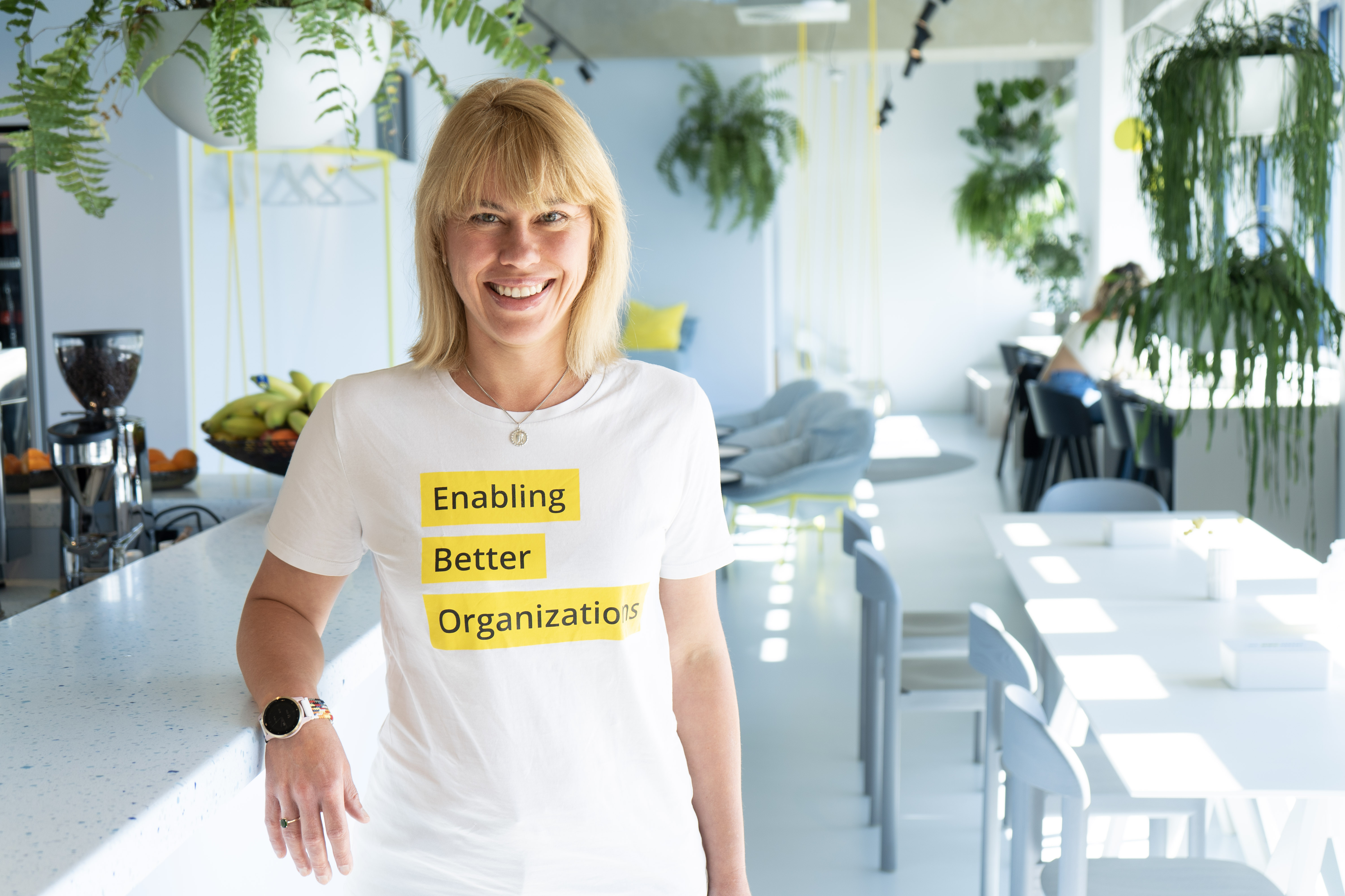 Desiree in Munich office leaning against counter