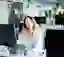 woman sitting in front of a computer in an office