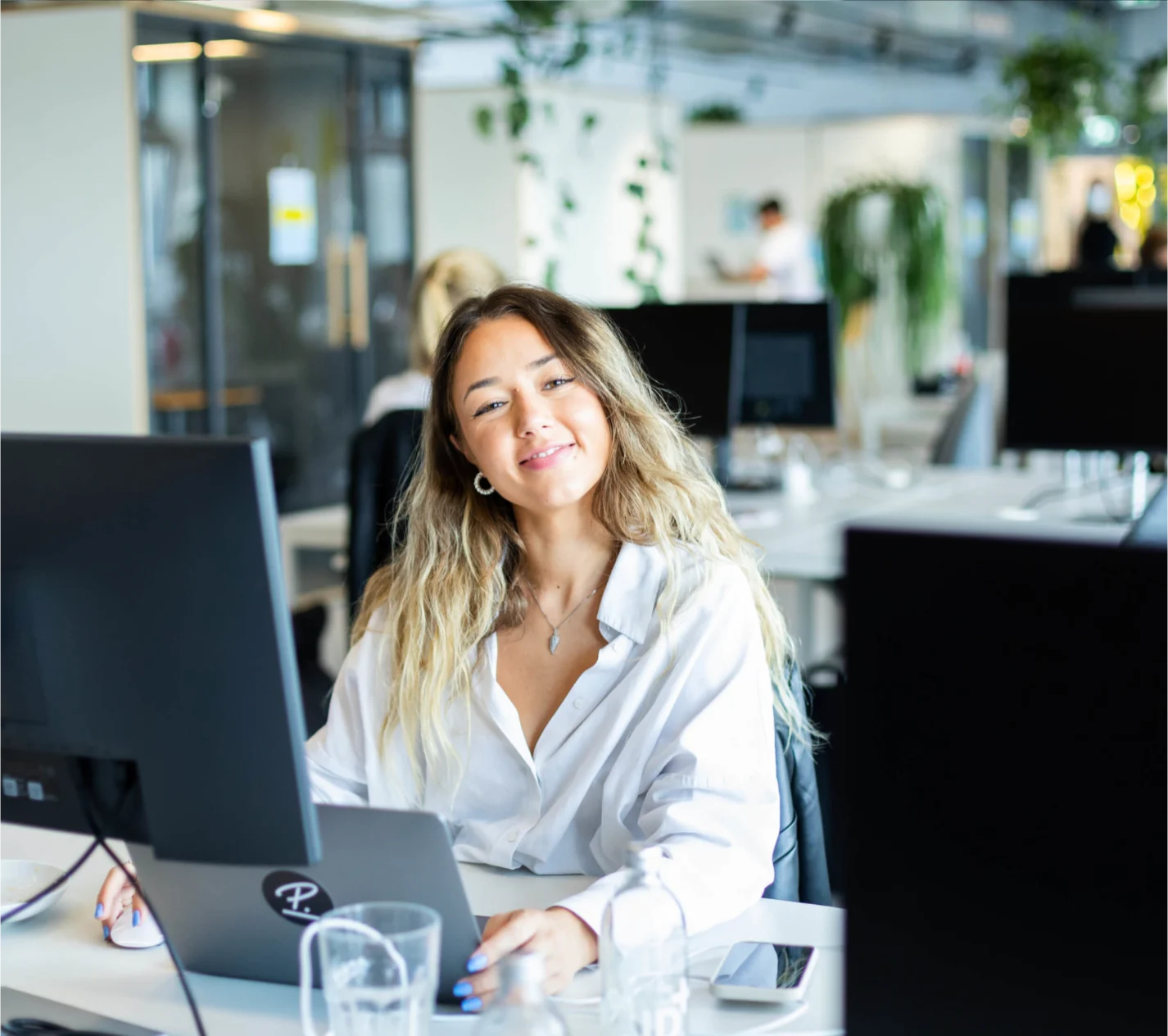 woman sitting in front of a computer in an office