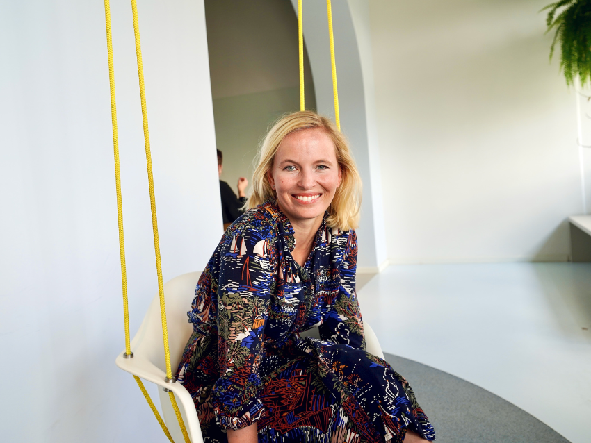 Woman sitting in swing smiling