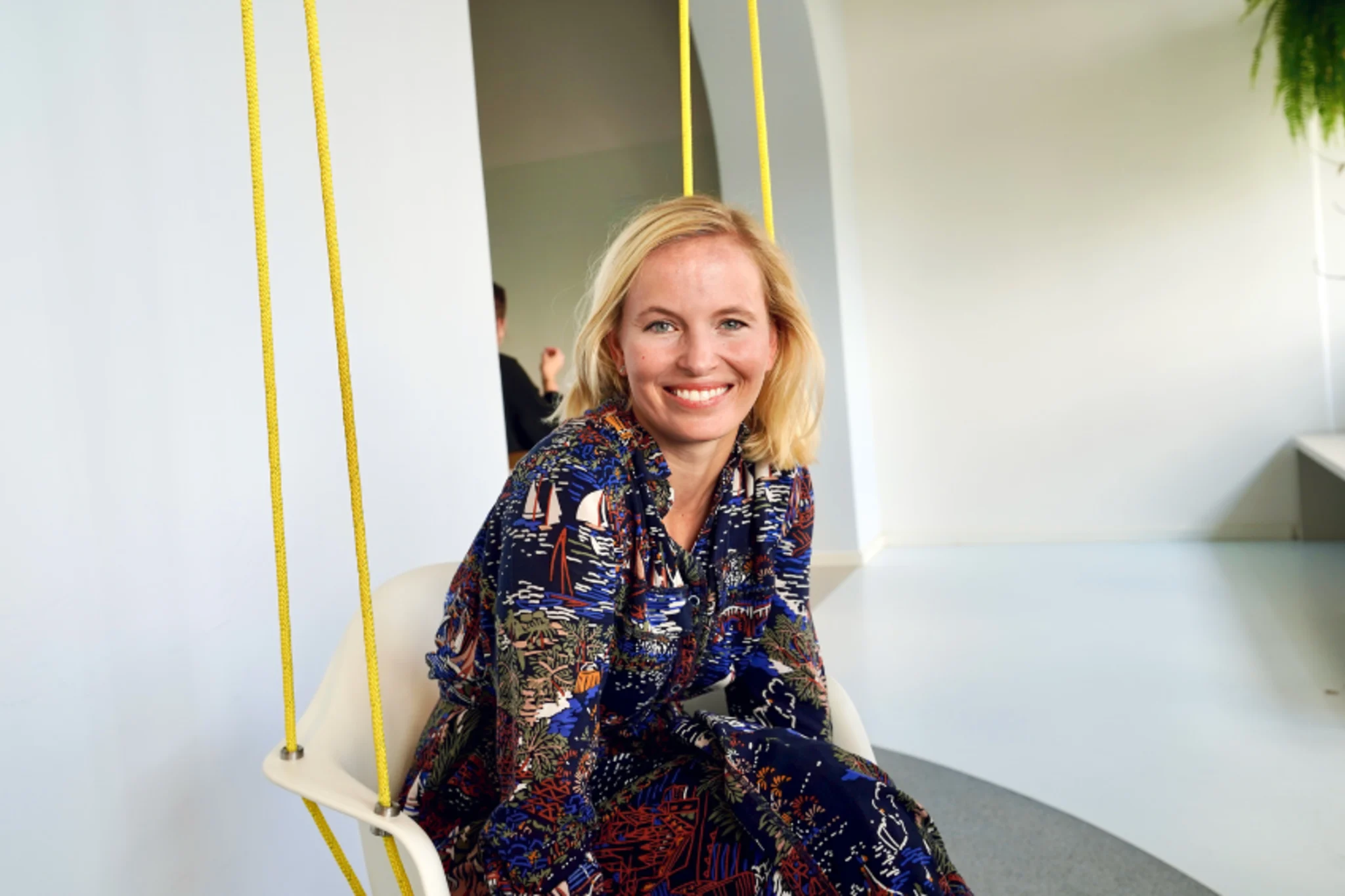 Woman sitting in swing smiling