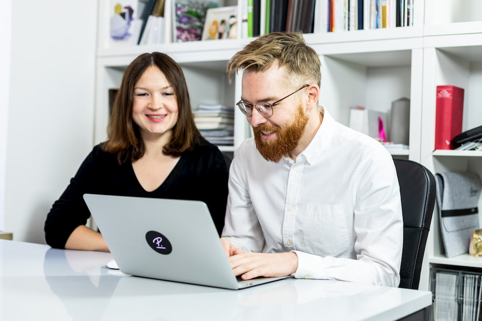 Two colleagues work on their social media recruiting strategy.