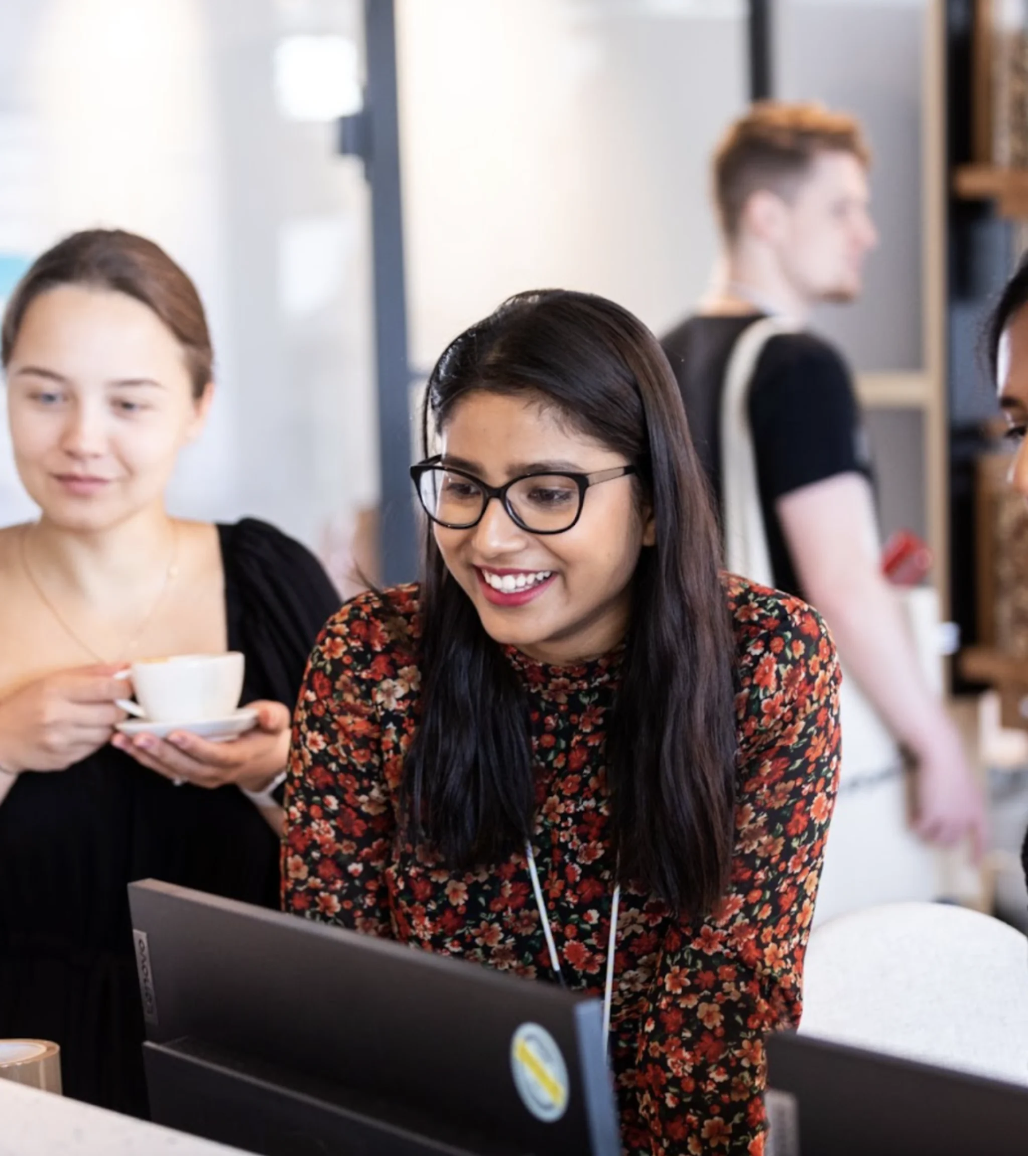 female colleagues looking at a computer screen