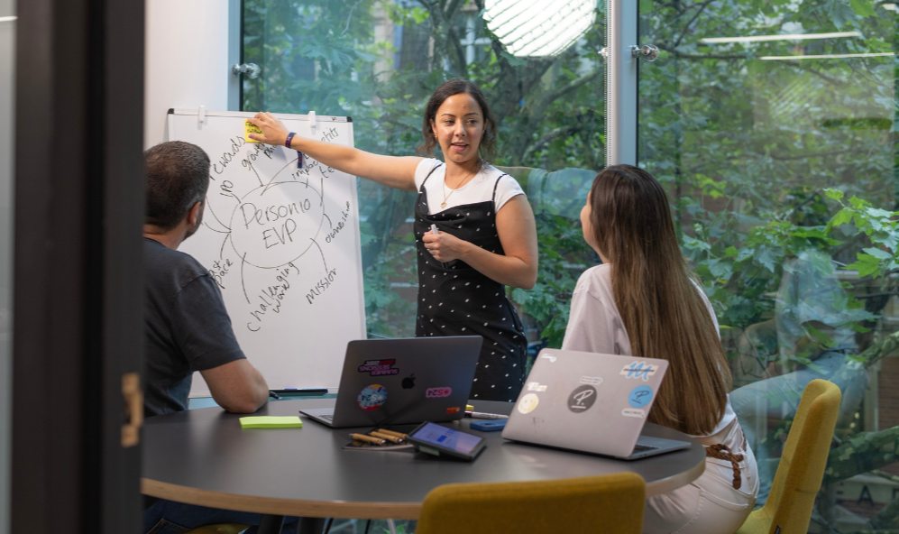 3 people in meeting with whiteboard