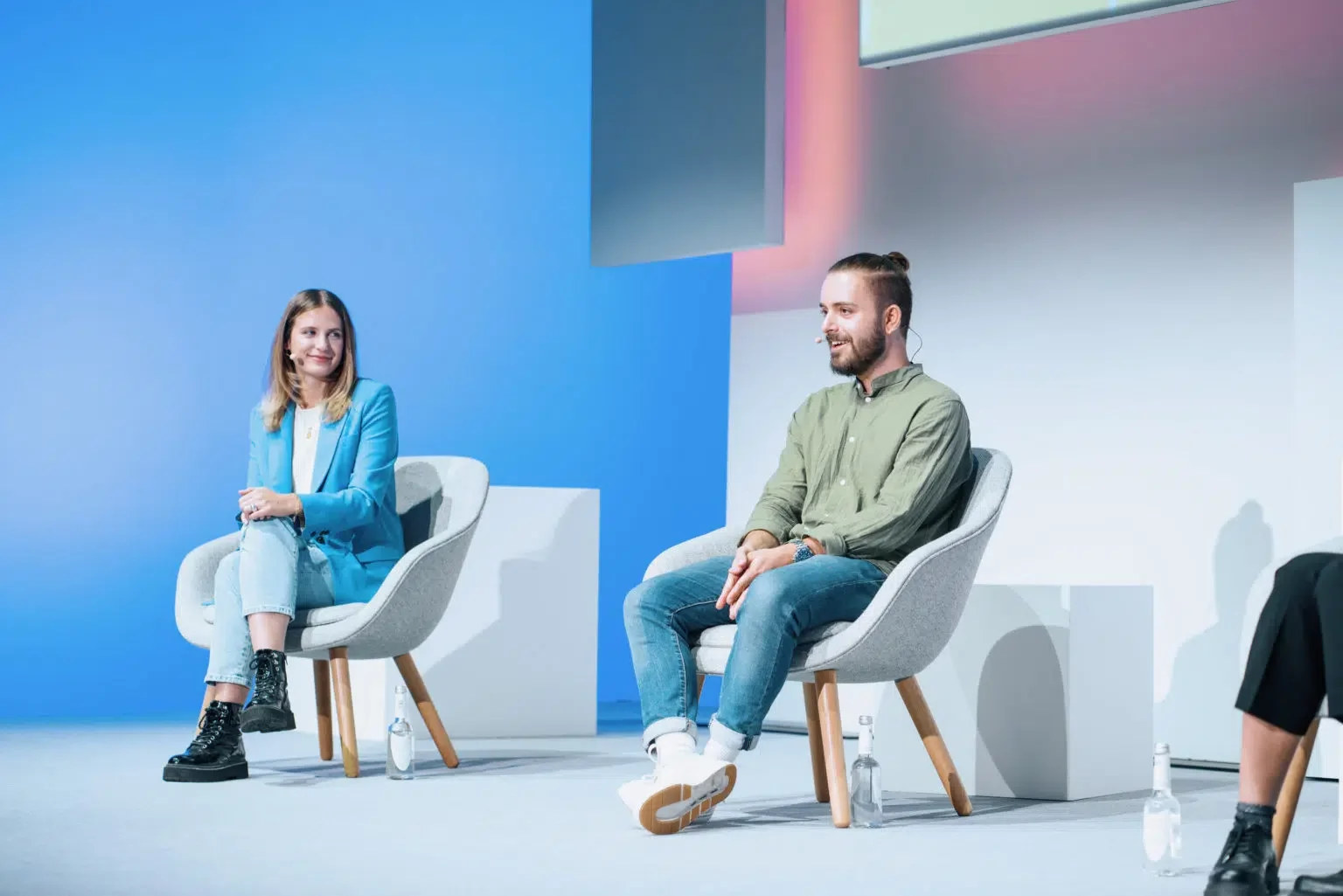 2 people sitting on a conference stage
