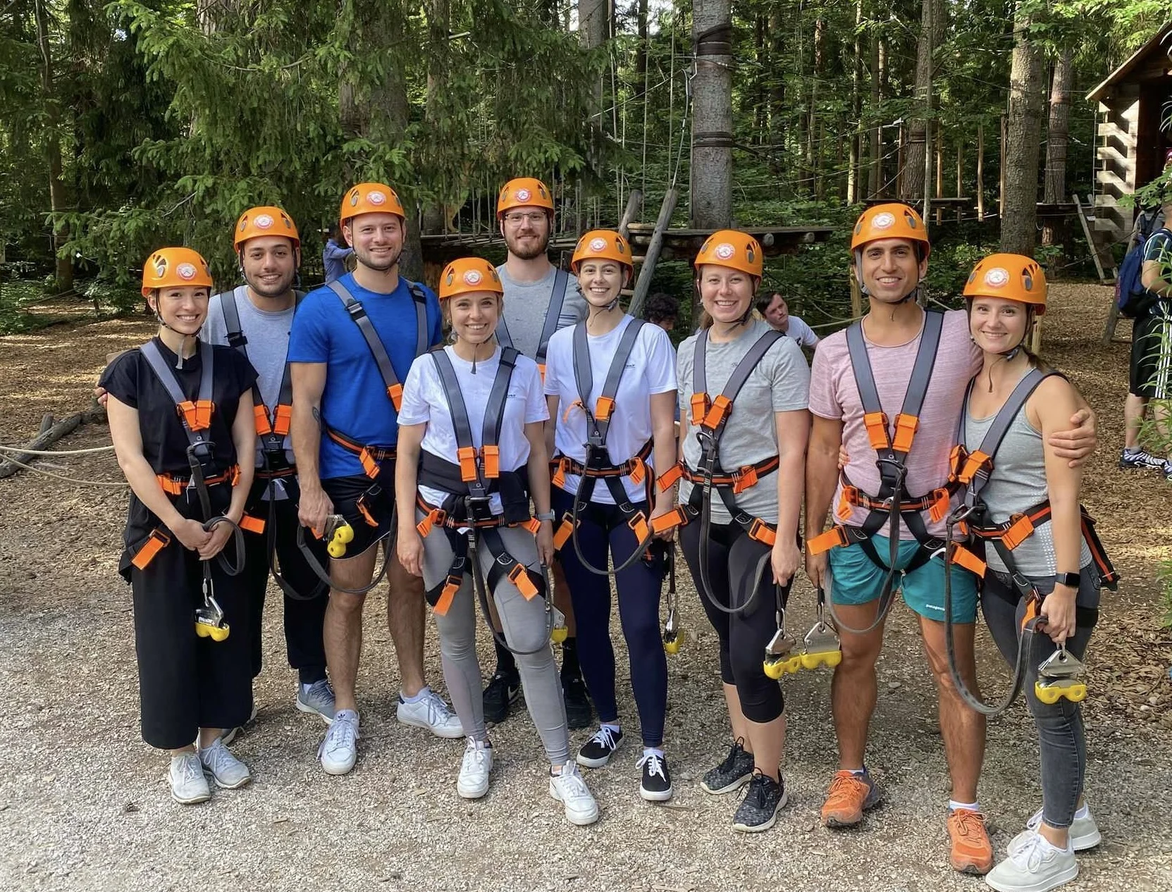 Group of 9 CX Personios standing outside of a ropes course