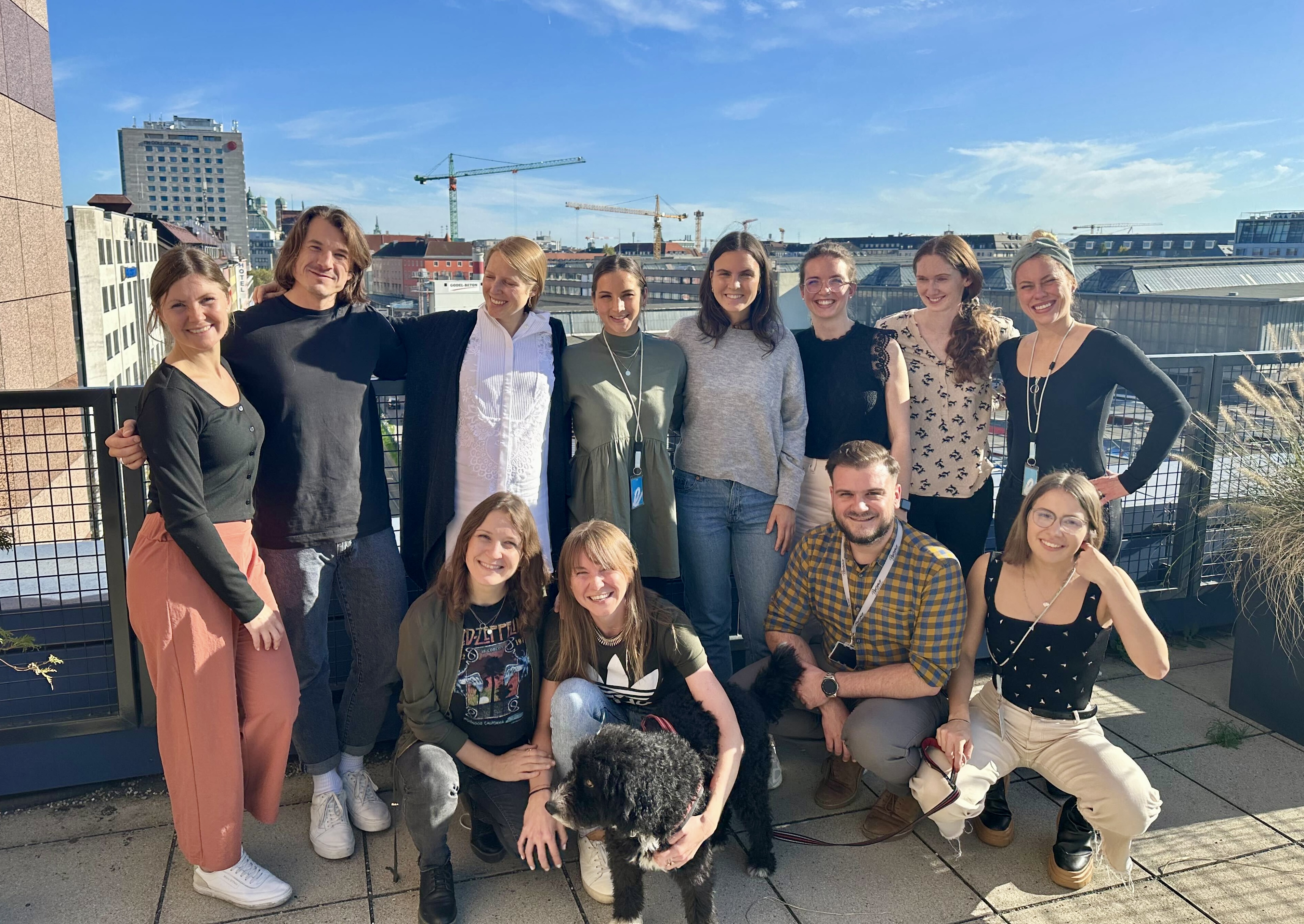 Group of Customer Experience Enablement team on balcony of Munich office