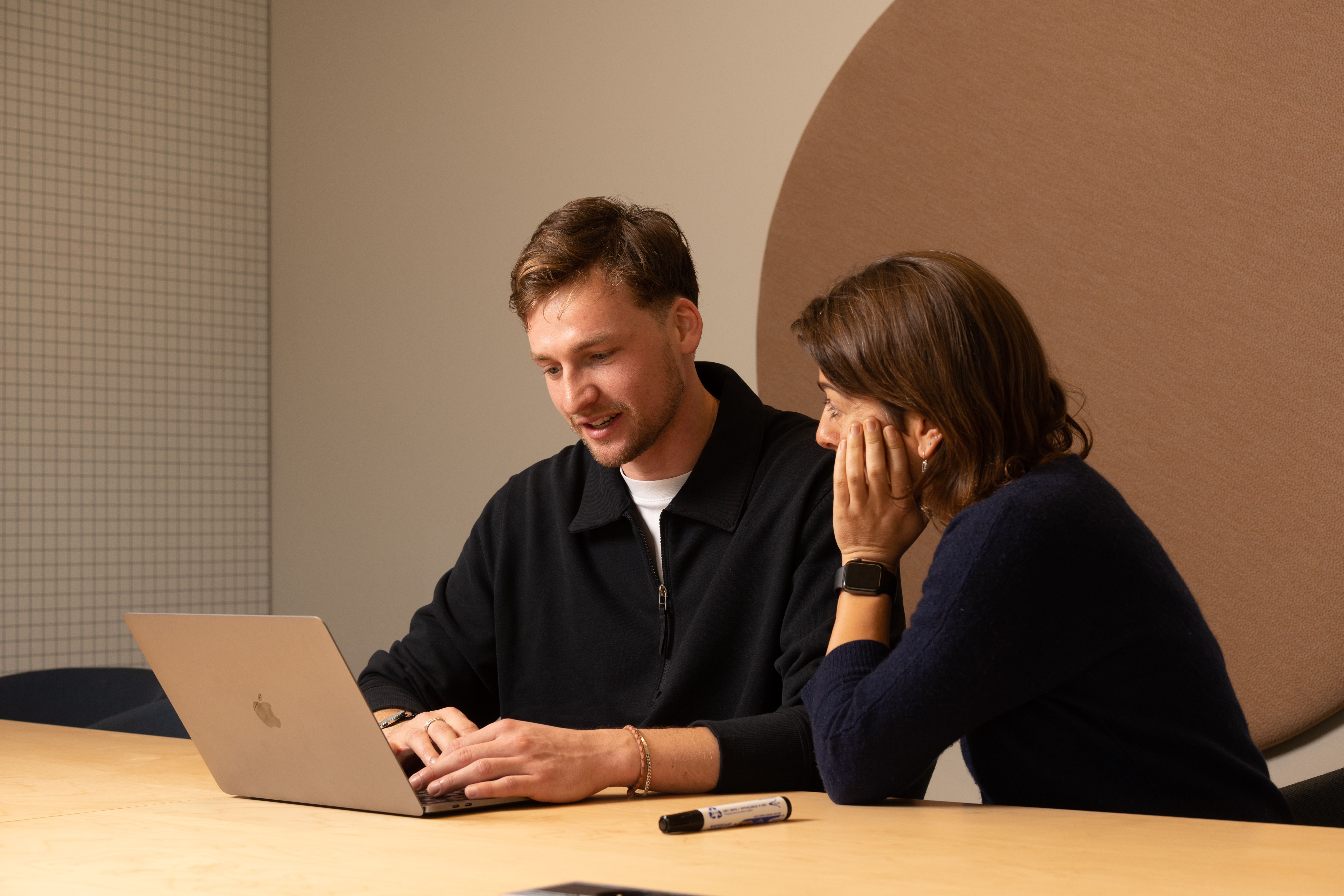 Two people looking at the laptop