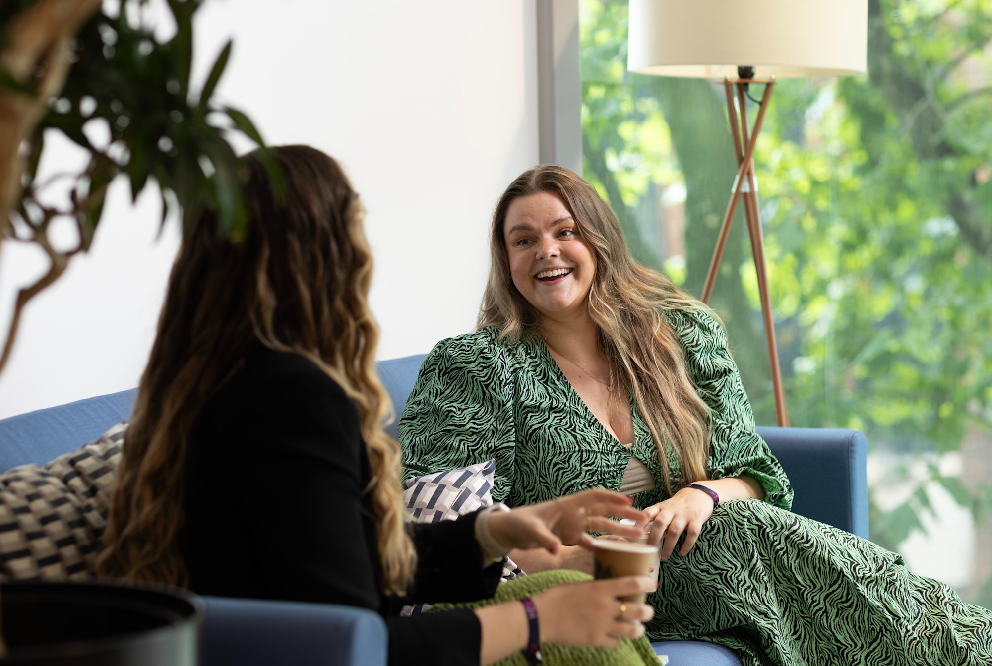 Two women smiling at each other