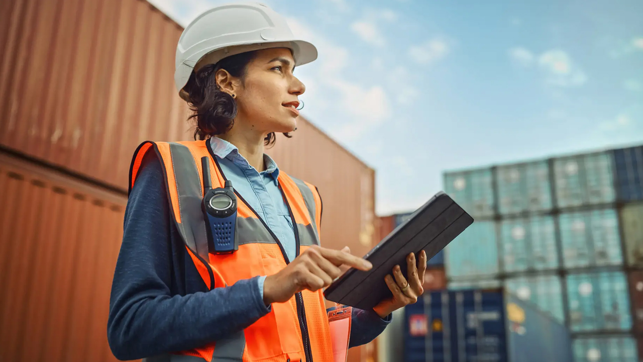 Person working at Harren Group with shipping containers in the background