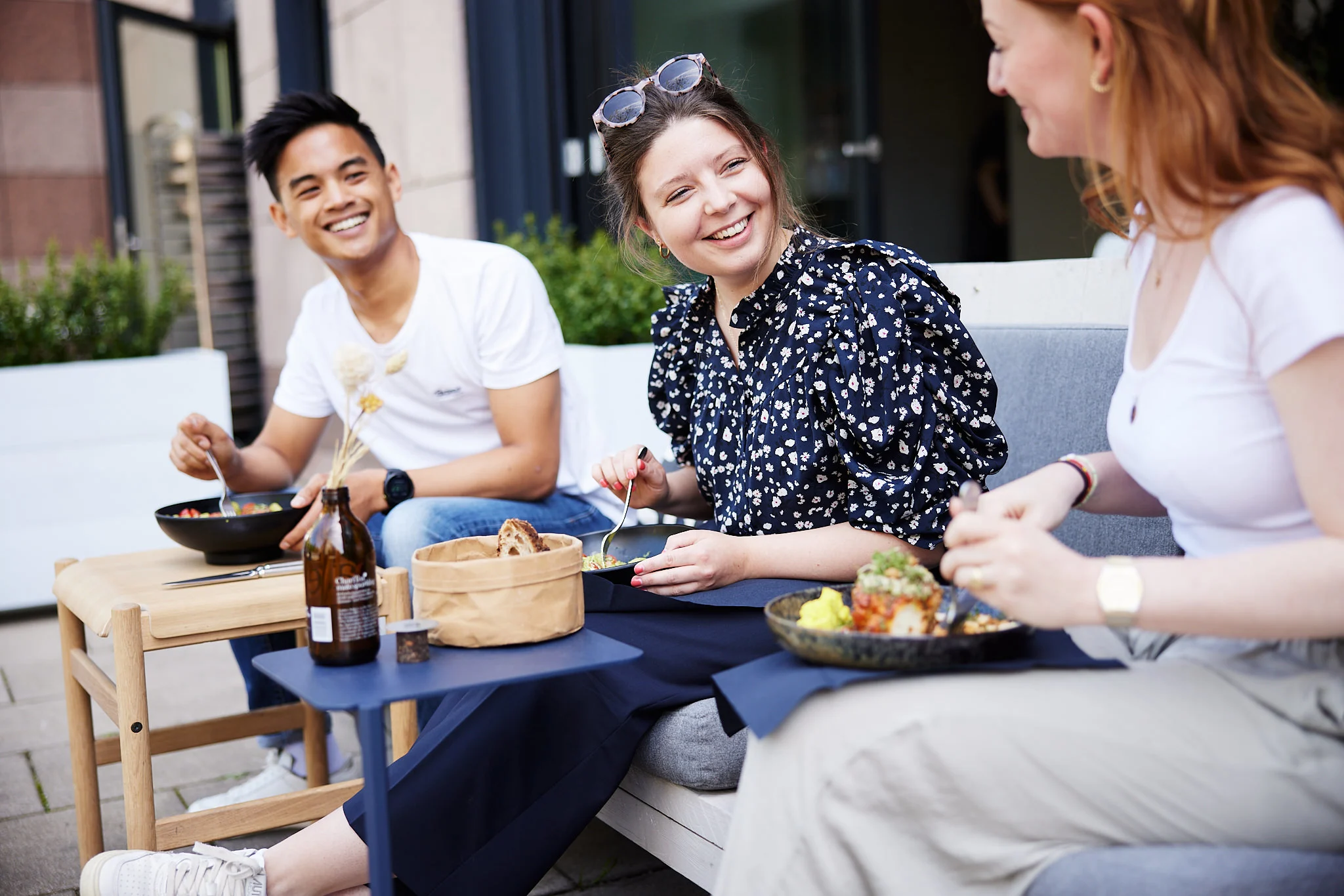 Culture cover page three people eating lunch outside