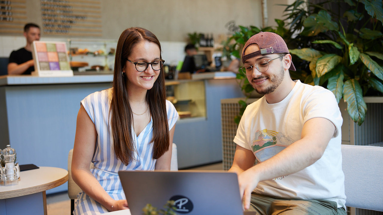 Man and woman pointing at laptop 