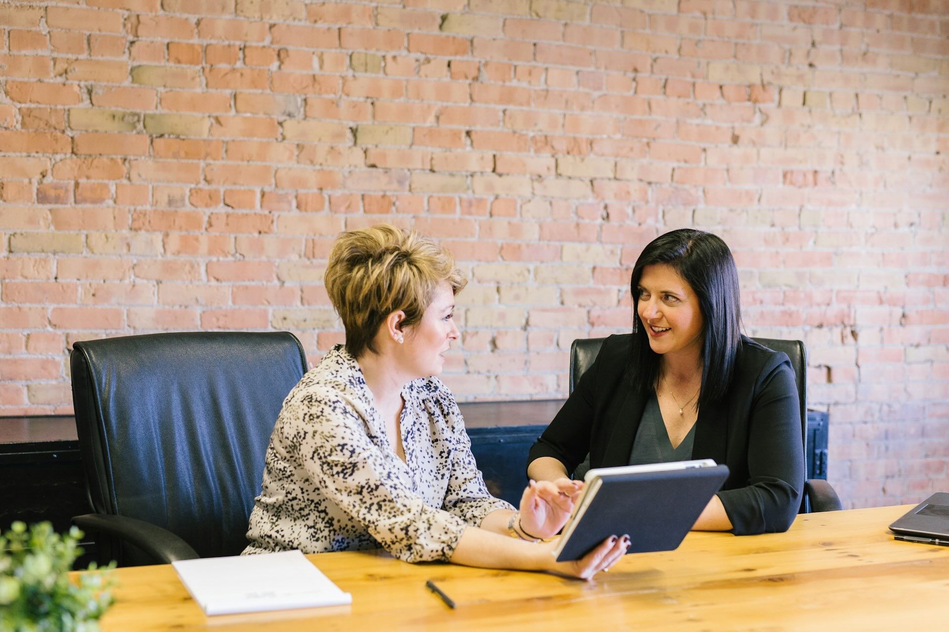 Image of two women sitting at a desk