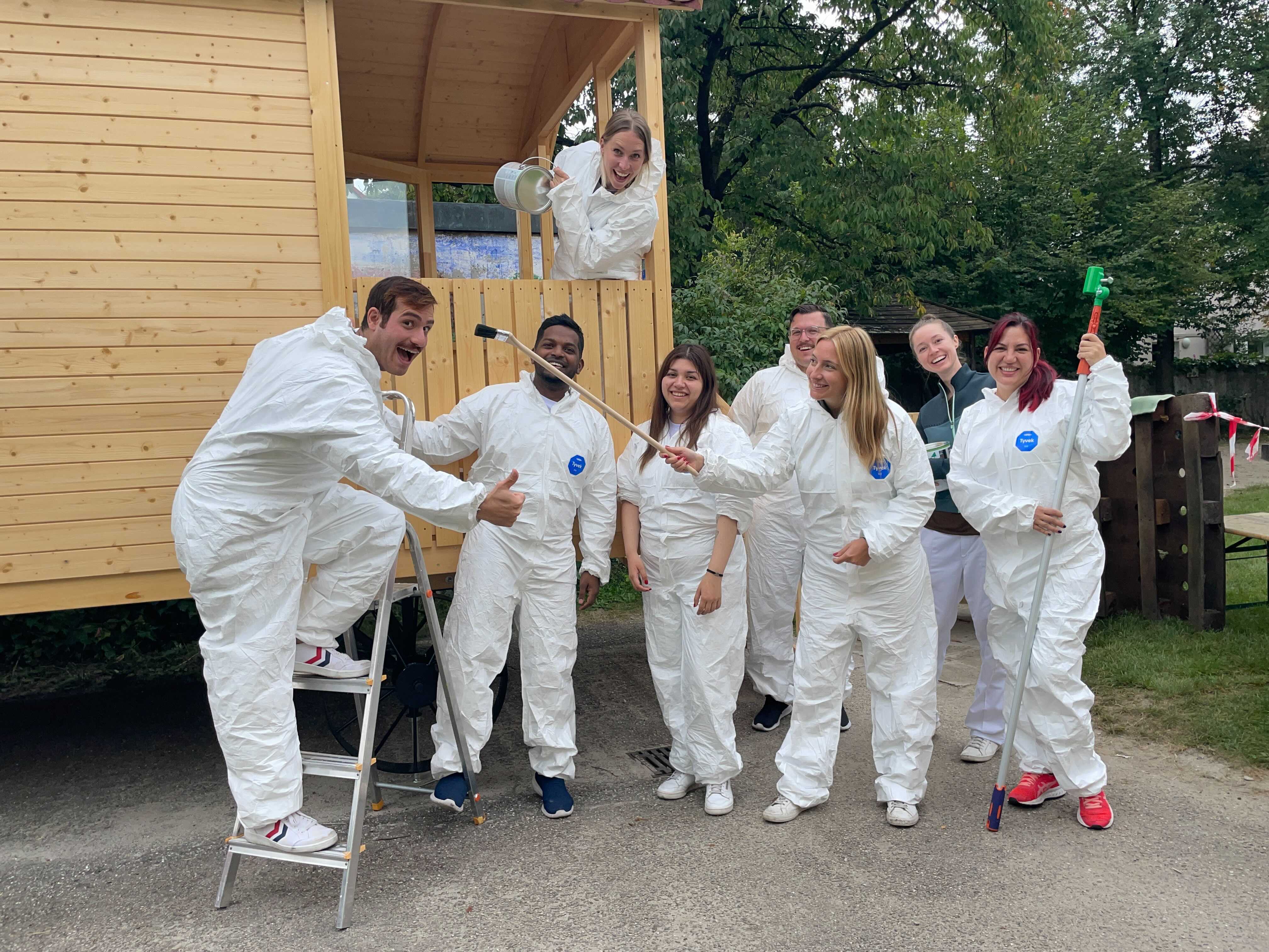 A Personio team painting the circus wagon