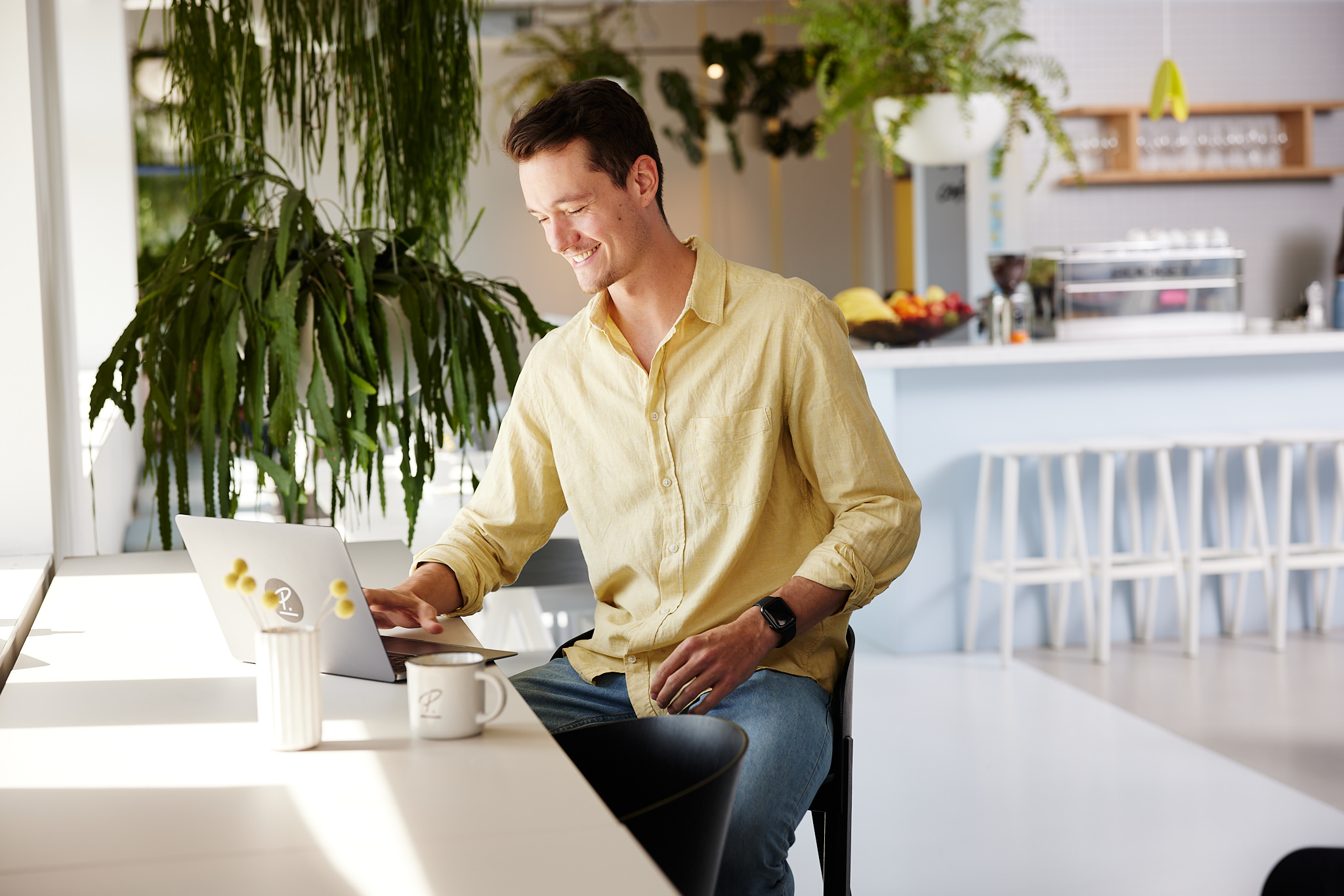 Employee working on laptop in the lounge