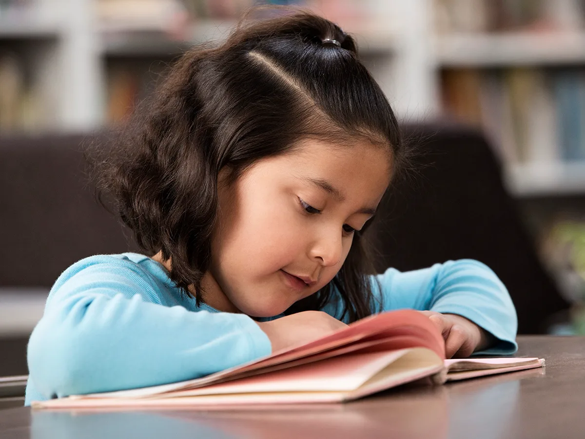 IEP goals for reading: What they look like, girl reading in school