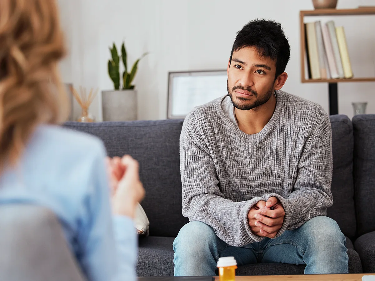Treatment for mental health issues. A young person speaks to their psychiatrist. 