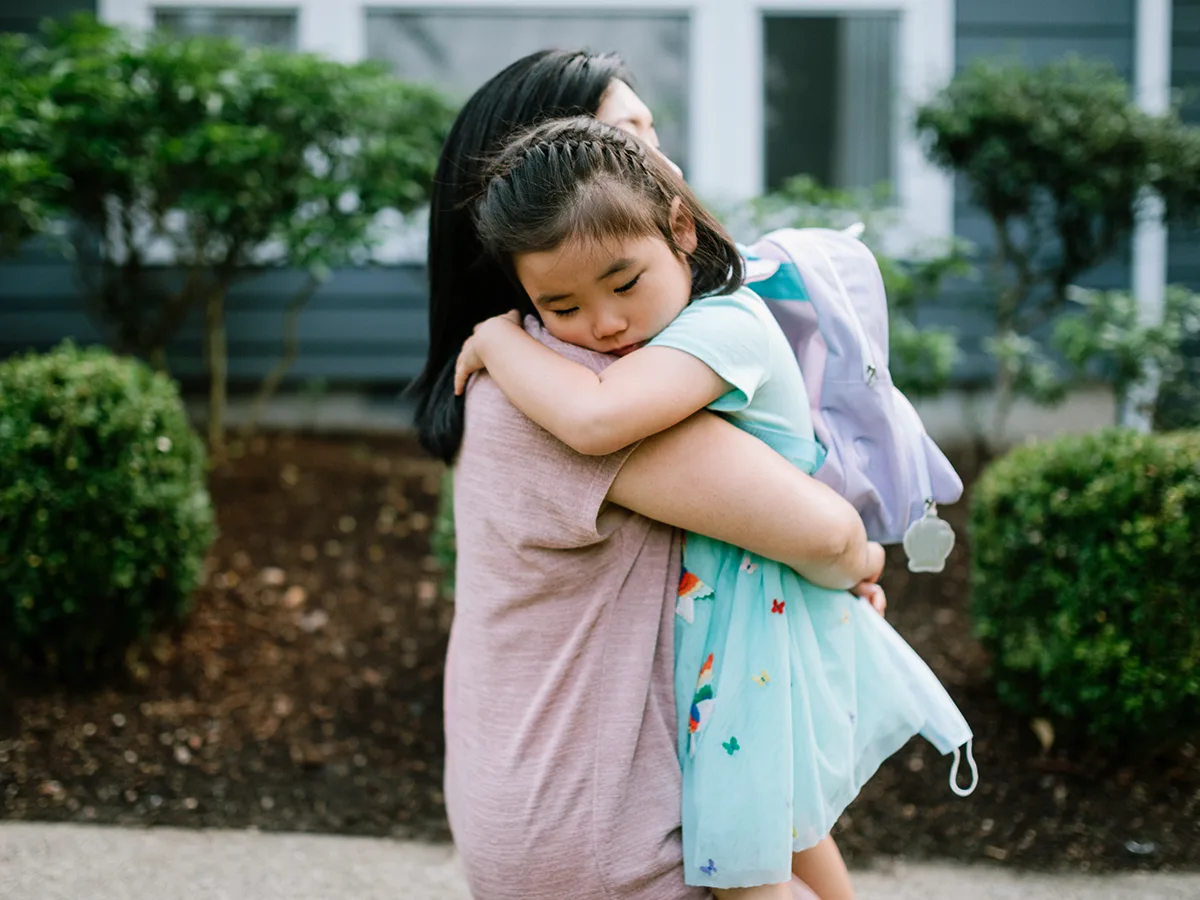 How can I help my child cope with back-to-school anxiety?, mom hugging child