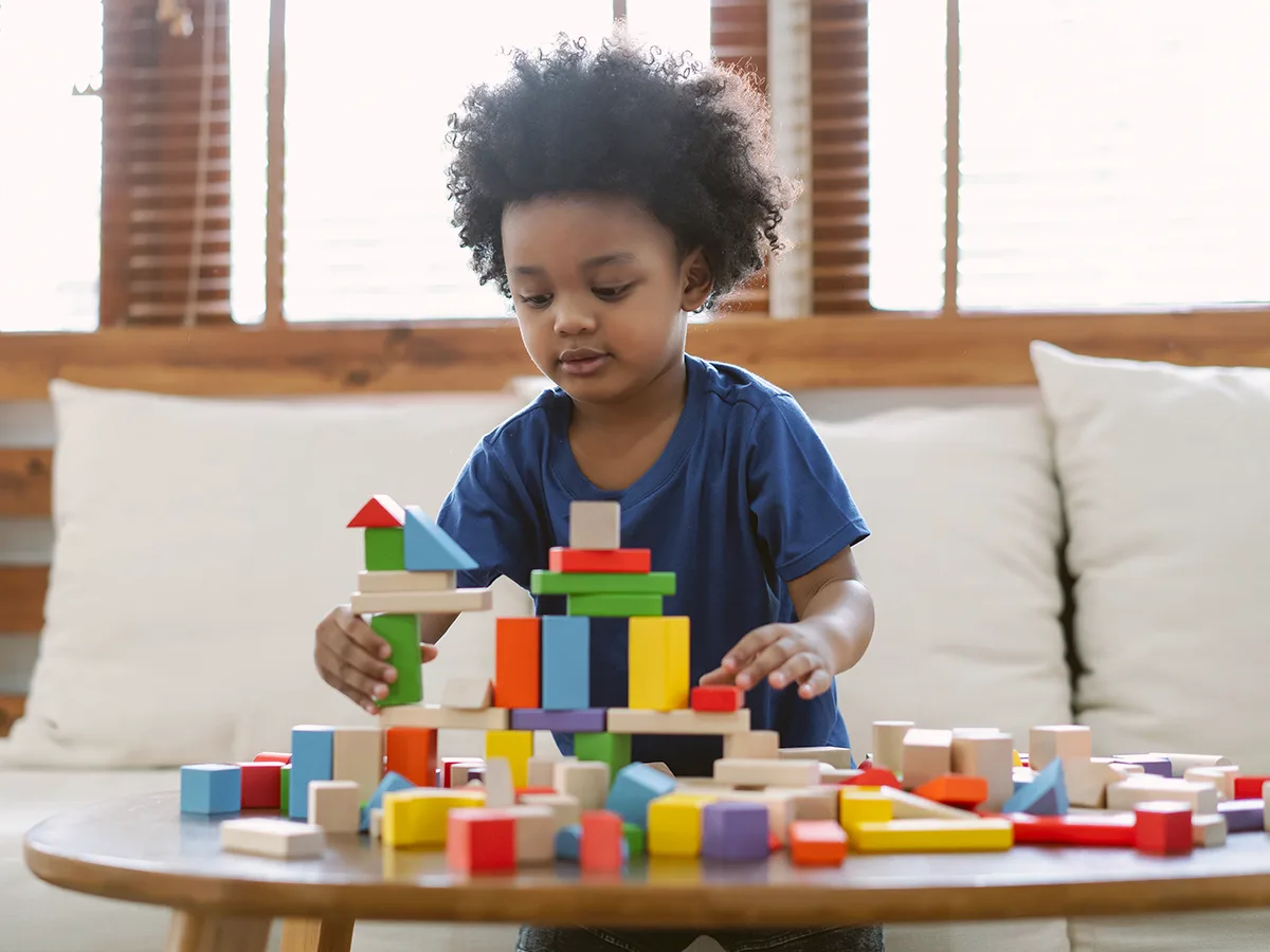 Developmental milestones for 2-year-olds, 2 year olds, little boy building with blocks