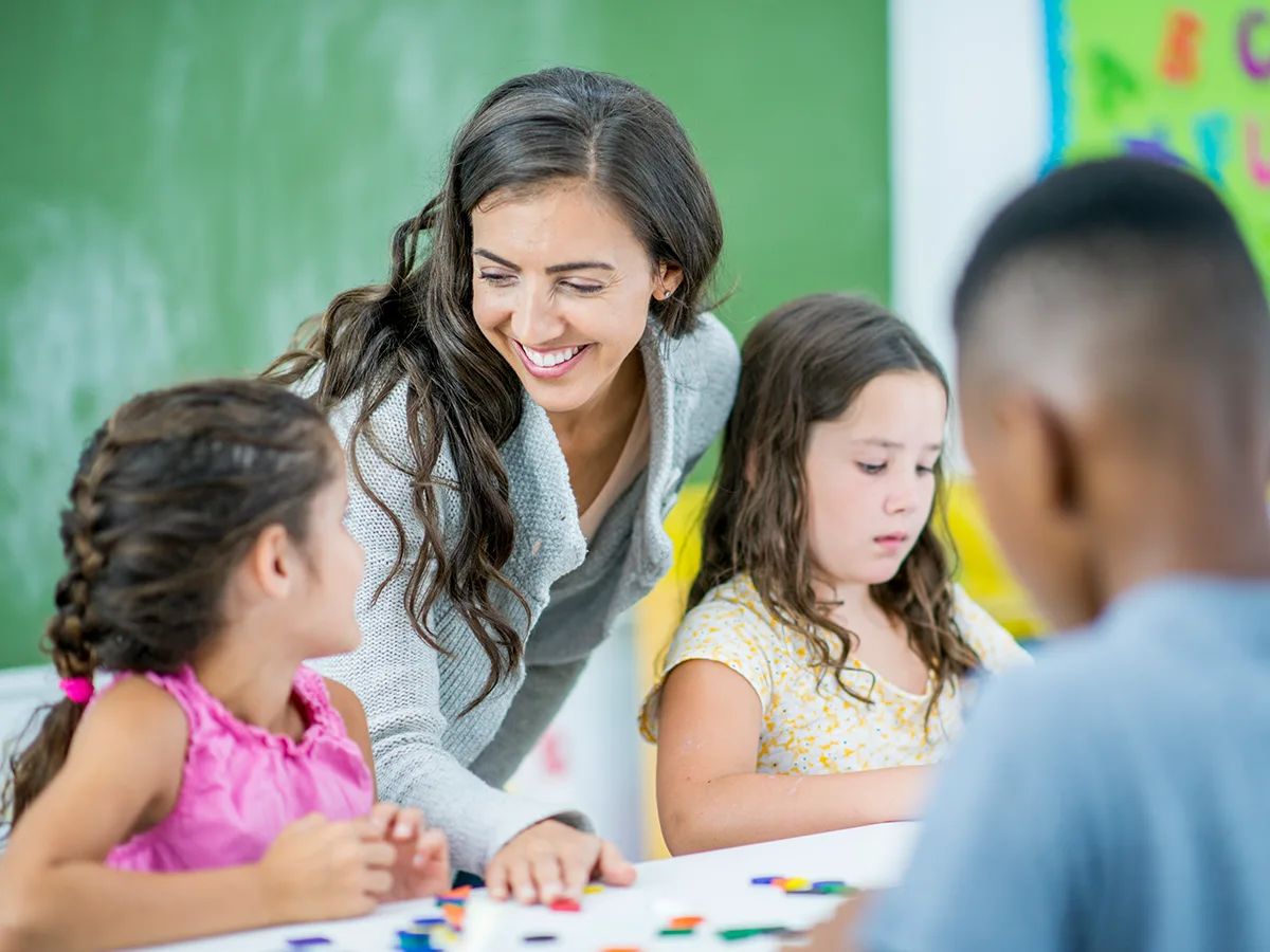 Elkonin sound boxes: An evidence-based literacy strategy, teacher talking to student in class