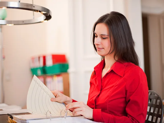 An adult looks at an IEP binder.