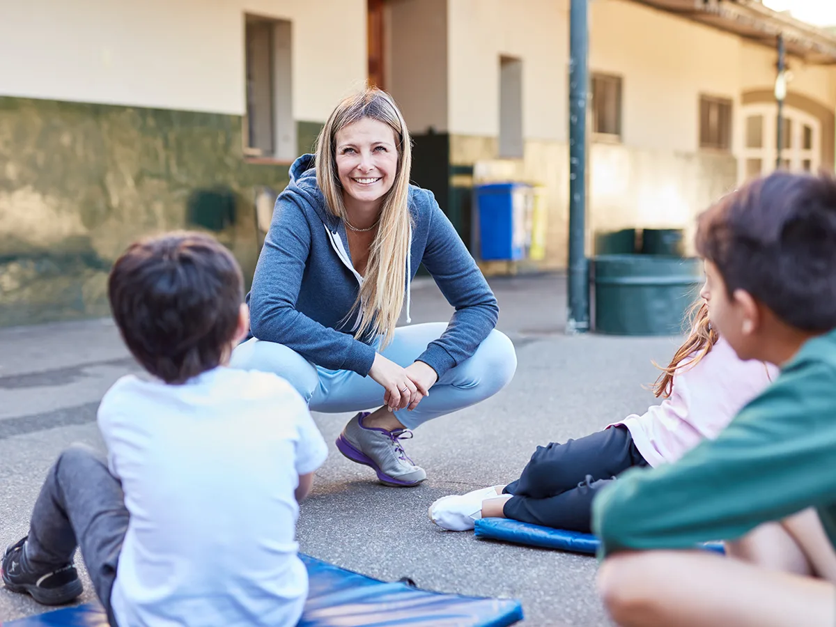 Pre-correcting and prompting: An evidence-based behavior strategy, teacher talking to students outside