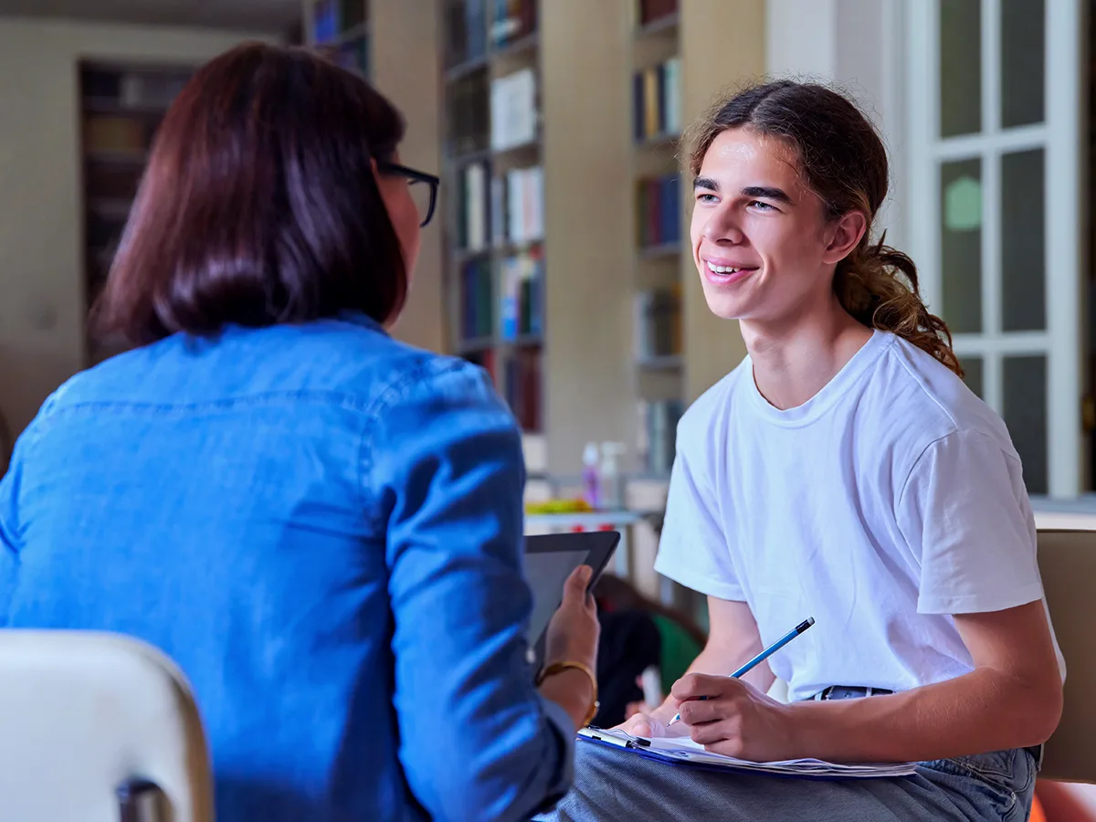 What is IEP transition planning? A teen student meets with a teacher. 
