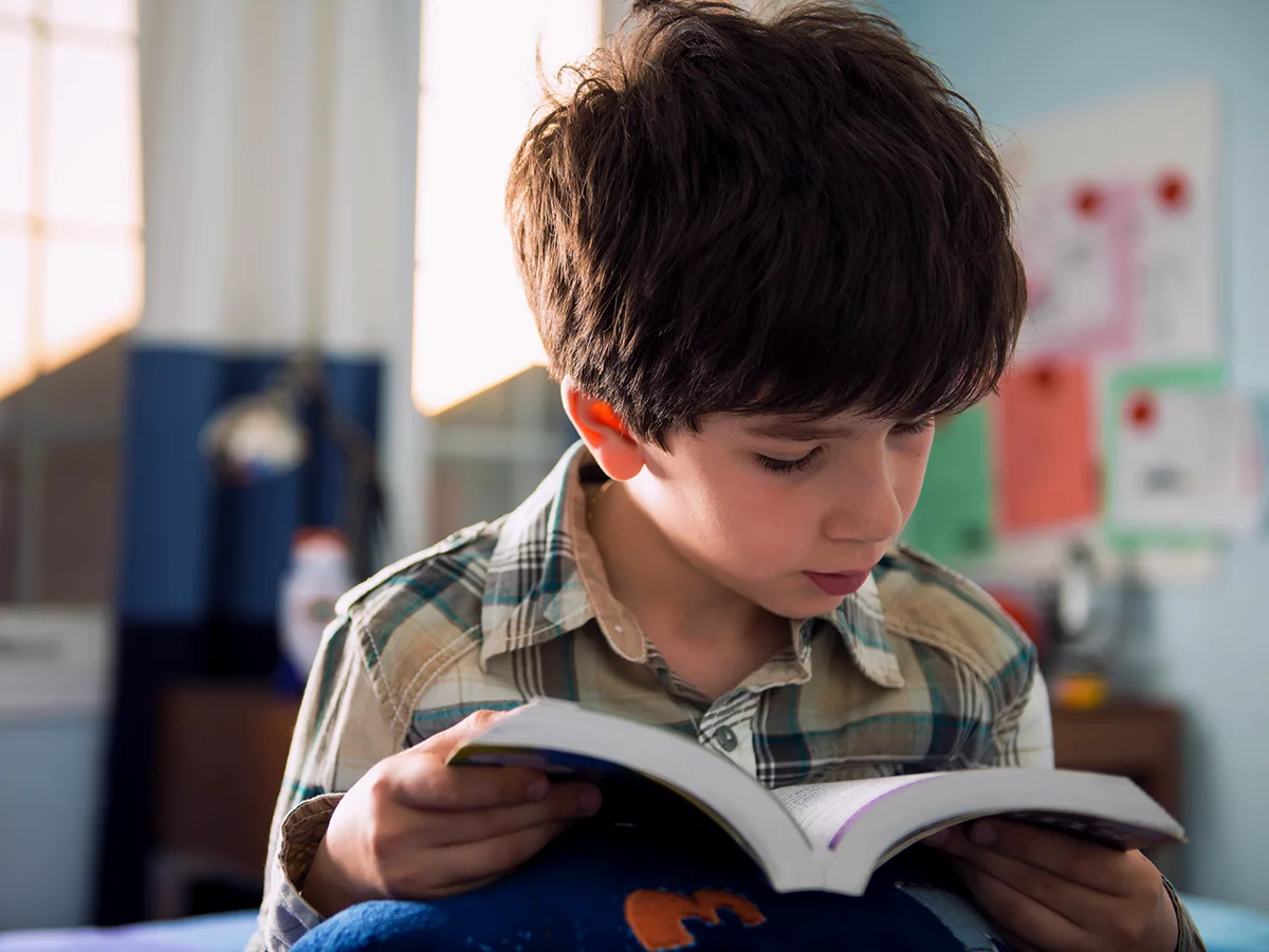 Reading speed and fluency: What you need to know. A young child reads a book. 