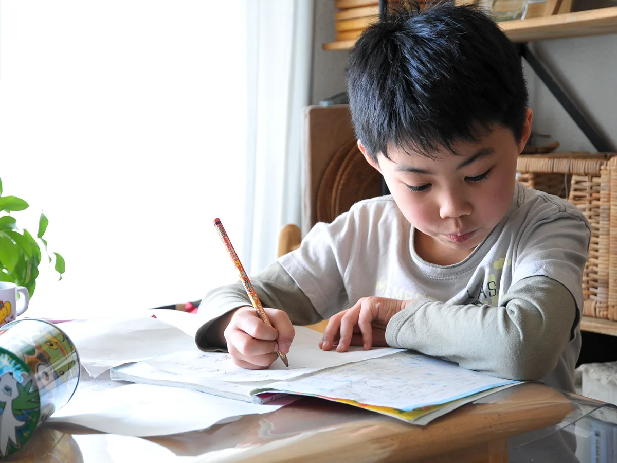 FAQs About Homework for Kids, kid doing homework at home