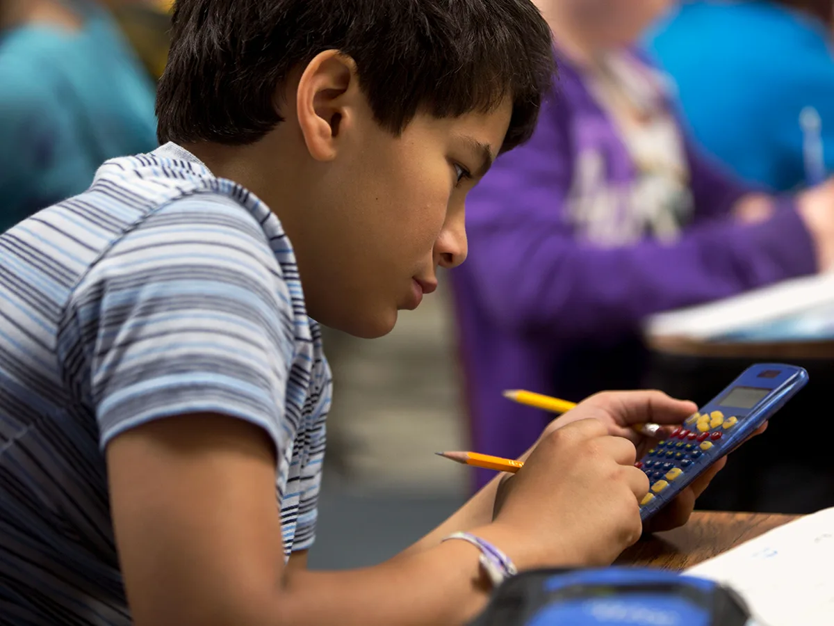 5 Ways Executive Functioning Issues Can Impact Math, kid using a calculator 
