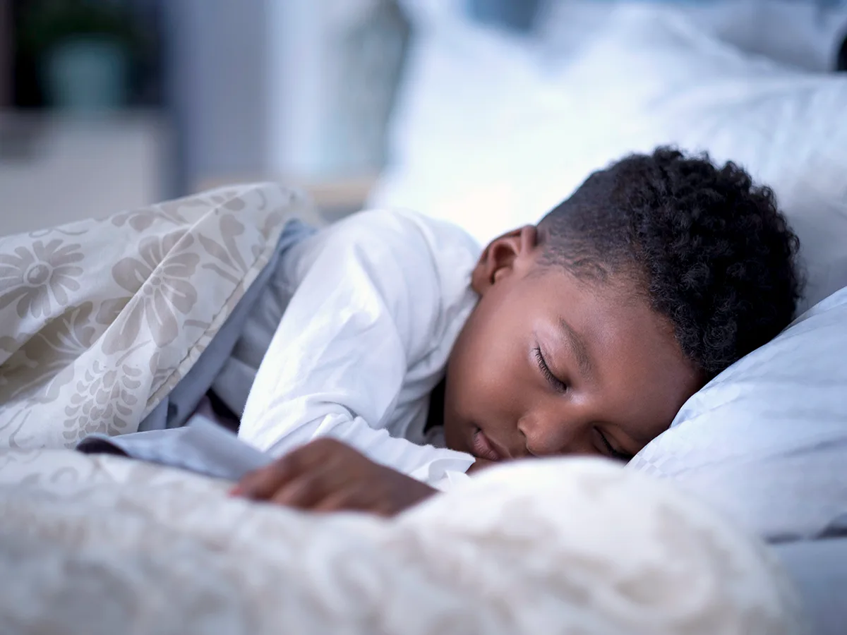 7 ways to get grade-schoolers on a school sleep schedule, boy sleeping