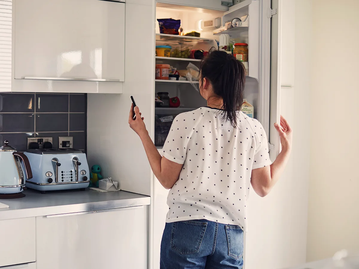 ADHD and eating disorders, woman standing in front of an open fridge
