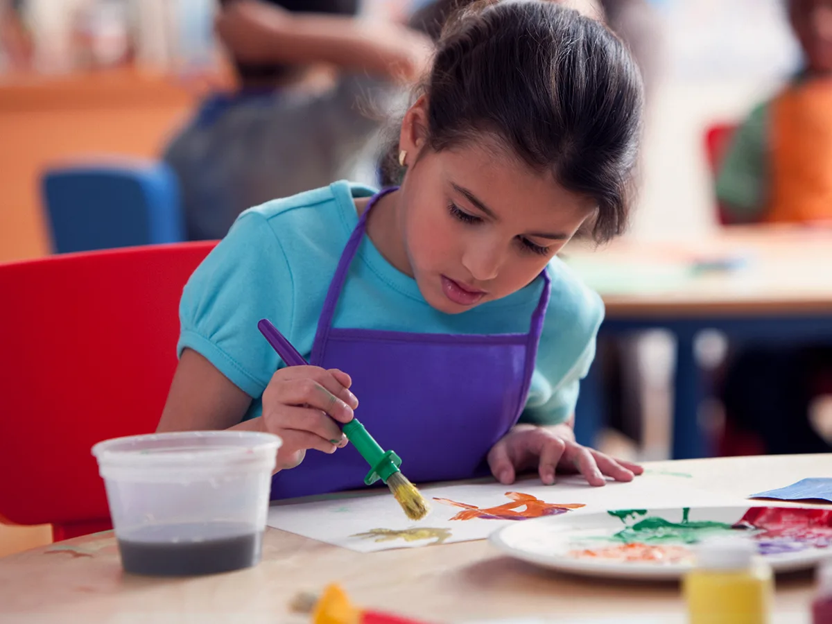 9 activities to help your child explore strengths and passions. A child paints in a classroom. 