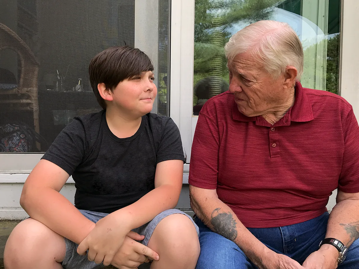 How to talk with your child about social-emotional issues, father talking to son on front step to house