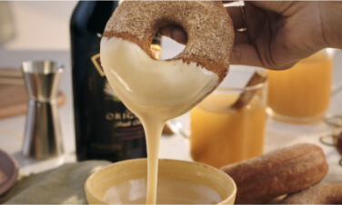 A donut that's just been dunked in icing.