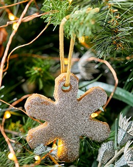 A Baileys Gingerbread Christmas tree decoration hanging off of a Christmas tree branch