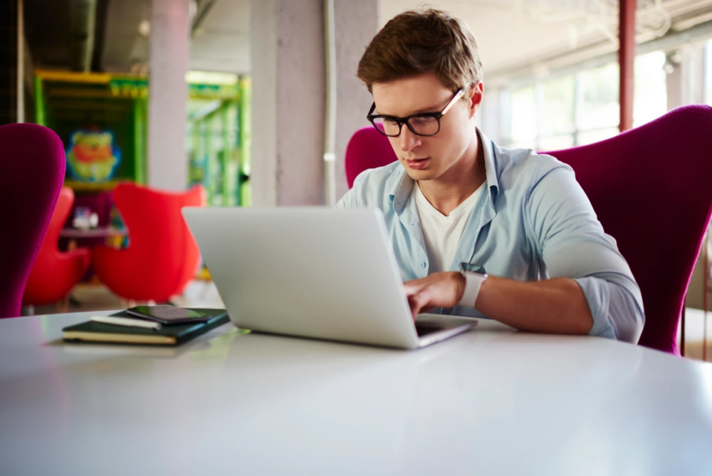 email marketer checking metrics on his laptop