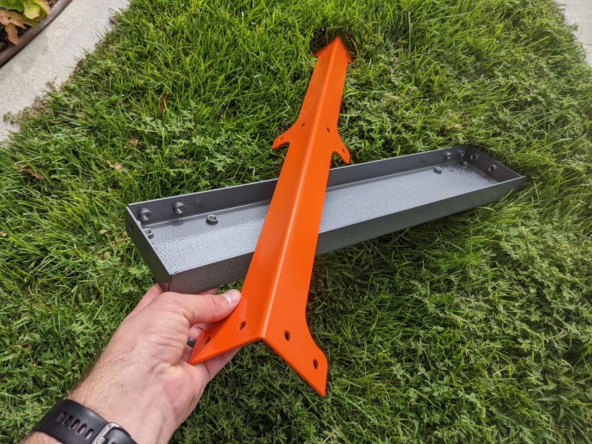 Powder coated parts shown stacked together on grass