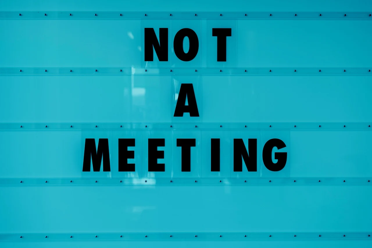 Blue sign with black letters 'Not A Meeting'