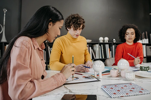 a man and two women in a meeting
