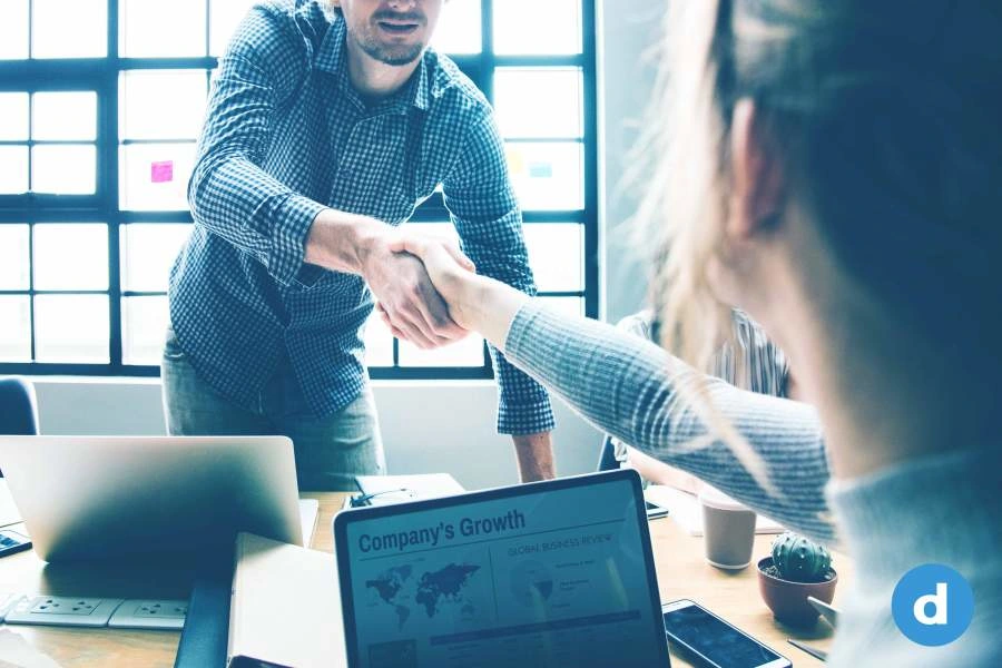 In a hiring process two people are shaking hands