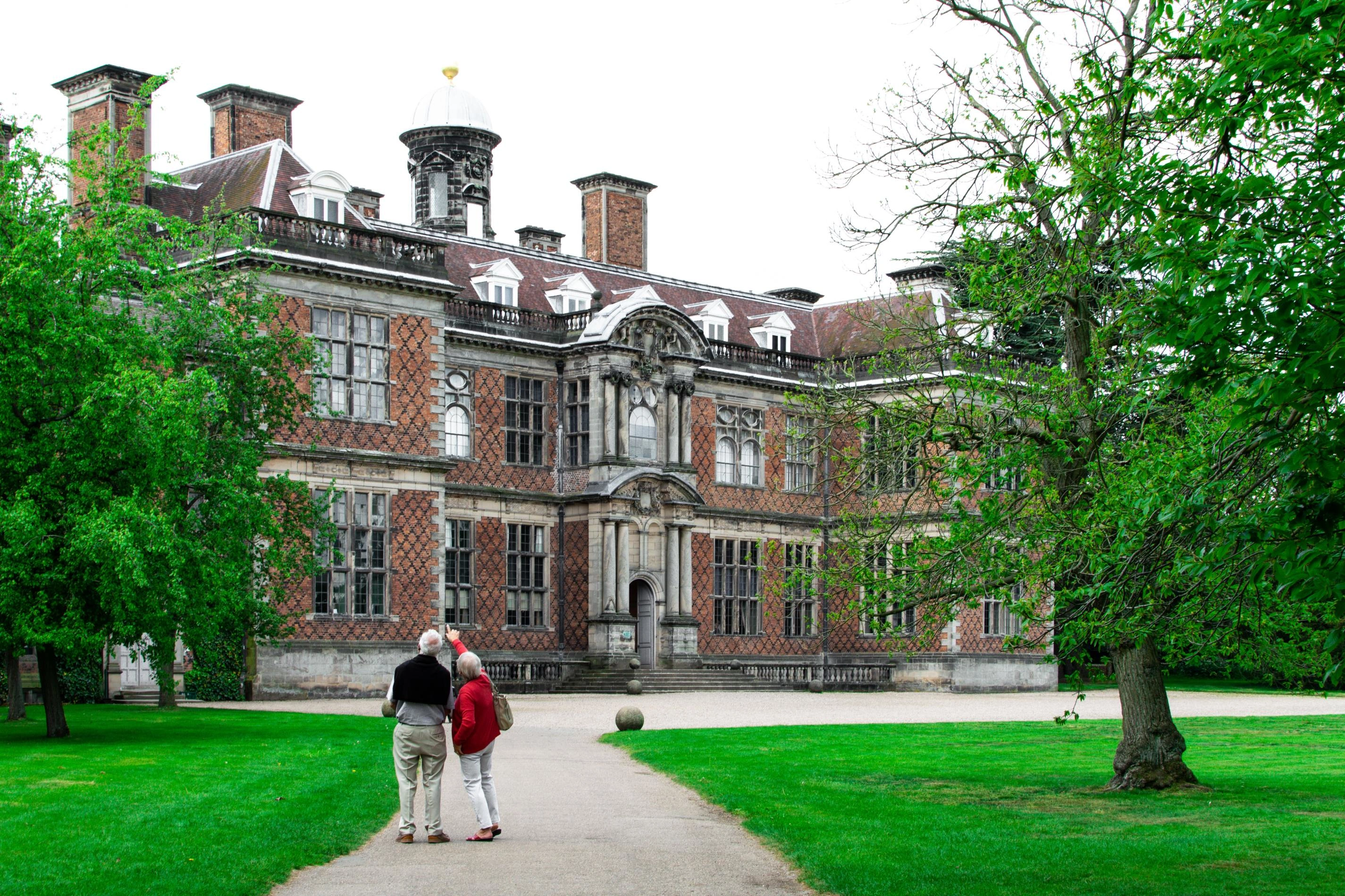 Two elder people looking at a university building