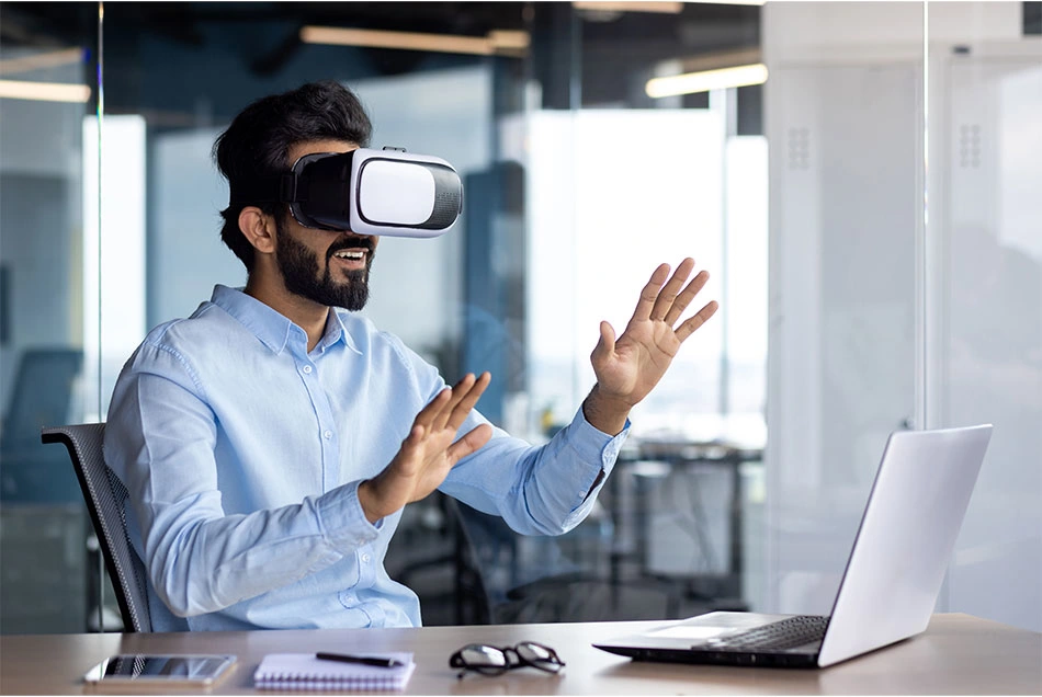 A man working by the desk with a VR and AI tool.