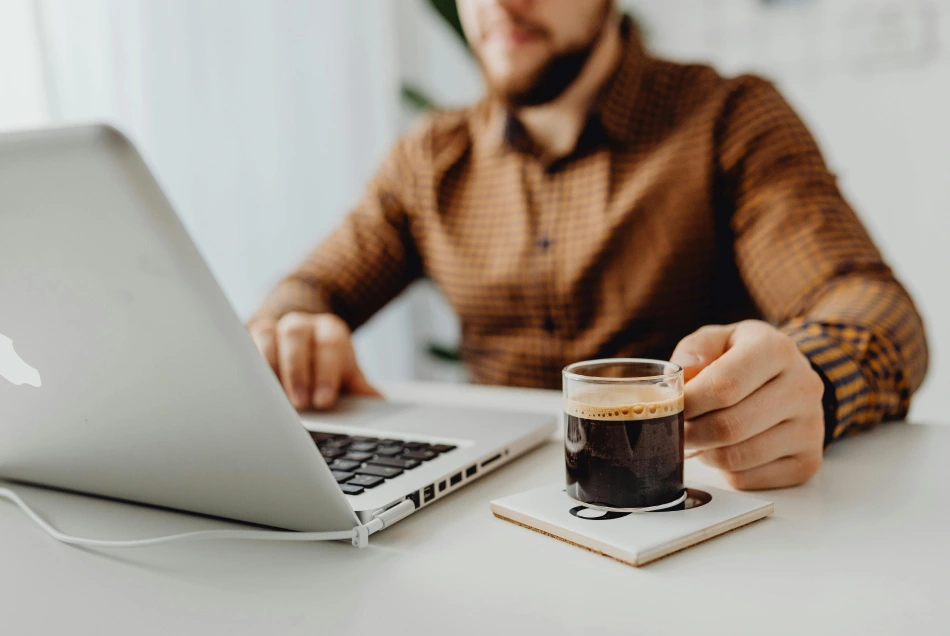man working at home with coffee