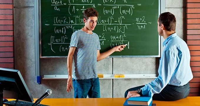 A young student and a professor doing maths