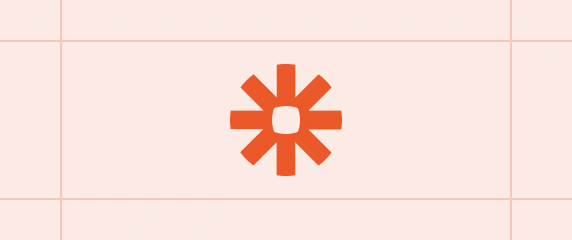 Logotipo de Zapier centrado sobre un fondo con patrón de cuadrícula.

