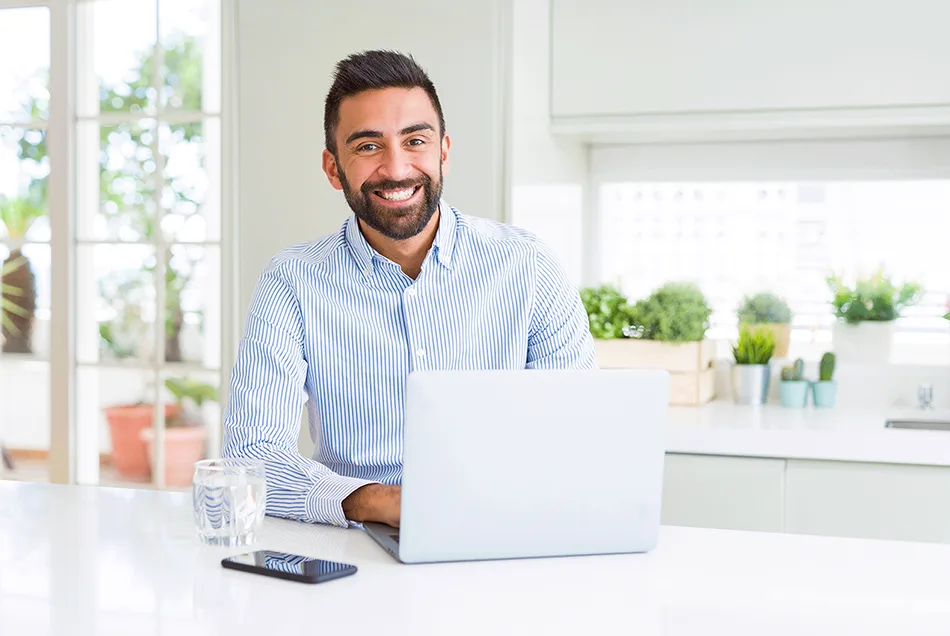 man with laptop and phone