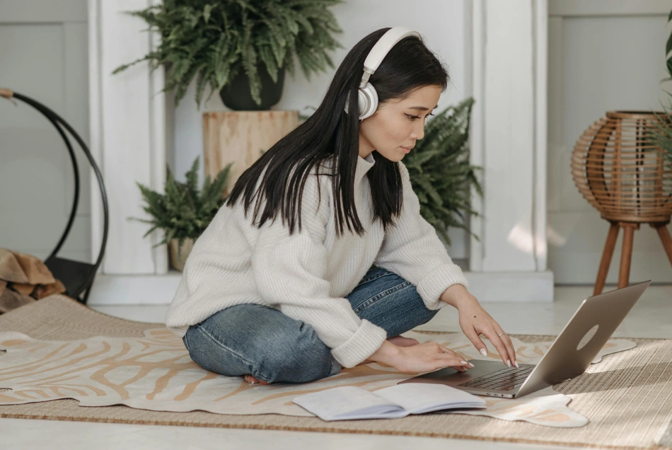 A woman is focused working in home office.