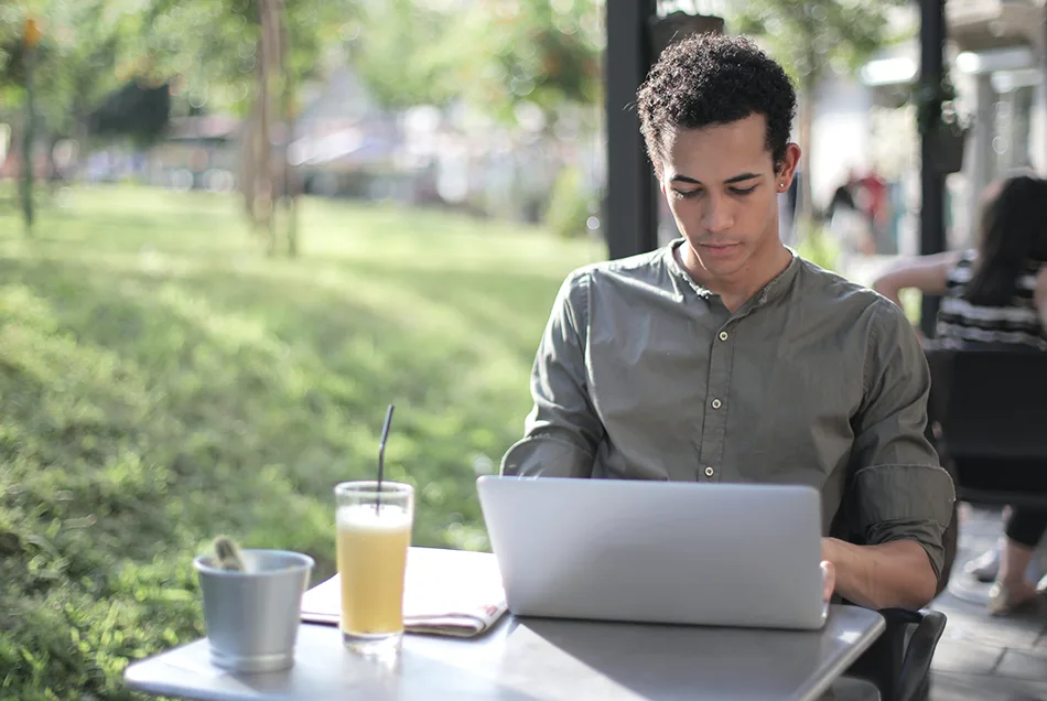 Man on laptop outside